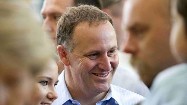 New Zealand Prime Minister John Key talks with wellwishers after placing his vote in the general election in Auckland.