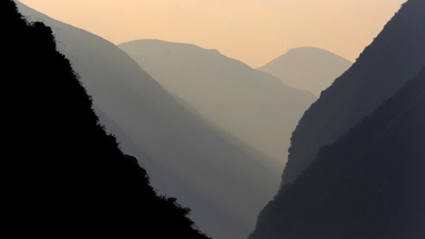 China's life line ... mountains dwarf a boat on the Yangtze.