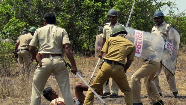 Police beat a man protesting against the Jaitapur nuclear project.