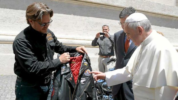 Pope Francis is shown a leather jacket by Harley-Davidson senior vice-president Mark Hans-Richer, at the Vatican, during the "Blessing of the Motorbikes".