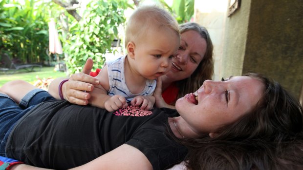 Jenn Hooper plays with her baby son Cody and daughter, Charley.