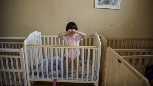 An orphaned Chinese girl in a foster care centre in Beijing.