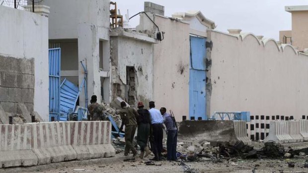 Warnings: Somali government soldiers arrive to secure the United Nations compound following a suicide bomb attack in the capital Mogadishu.