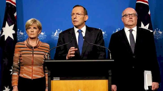 Prime Minister Tony Abbott with Foreign Minister Julie Bishop and Attorney-General Senator George Brandis in Canberra on Tuesday.