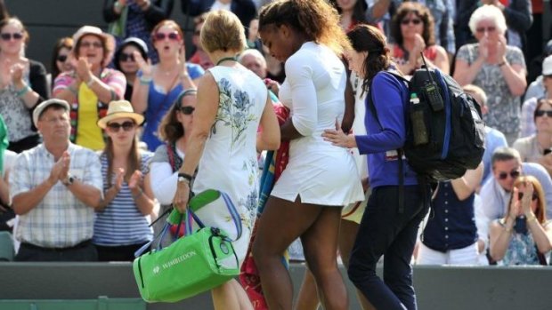 Serena Williams is assisted from the court.