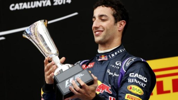Daniel Ricciardo admires the silverware he won for placing third in Barcelona.