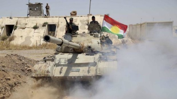 'New Iraq': Kurdish peshmerga troops flying the Kurdish flag patrol part of Iraq's Salahuddin province.