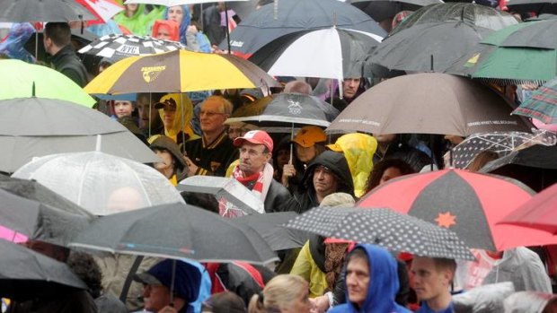 Resolute fans brave the wet for yesterday's grand final parade through Melbourne.