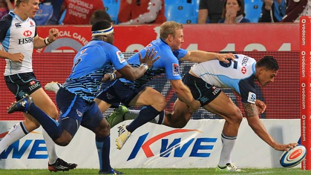 Rare bright moment: Israel Folau of the Waratahs scores a try despite being pursued by Jano Vermaak of the Bulls during NSW’s 30-19 loss at Loftus Versfeld.