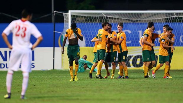 Australian forward Corey Gameiro celebrates with his team mates after scoring his third goal against Jordan.