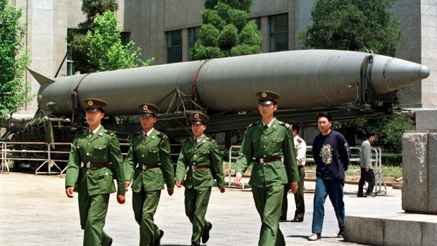Chinese soldiers march past a missile on display at Beijing's Military Museum.