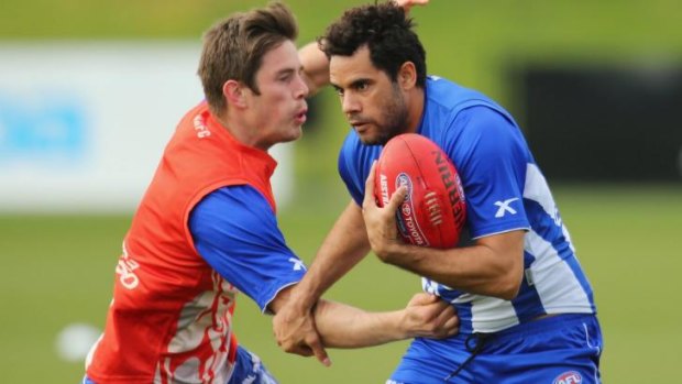 Daniel Wells (right) is tackled by Ryan Bastinac during a North Melbourne training session on Thursday.