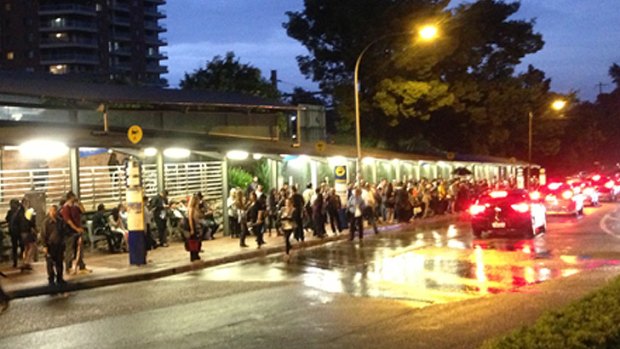 Commuters wait outside Strathfield station on Friday night.