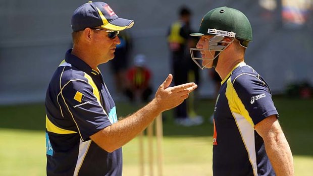 Brad Haddin (R) speaks to coach Micky Arthur while batting during an Australian nets session at Adelaide Oval in January 2012.