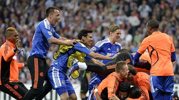 Chelsea players celebrate Didier Drogba's game-winning penalty kick.