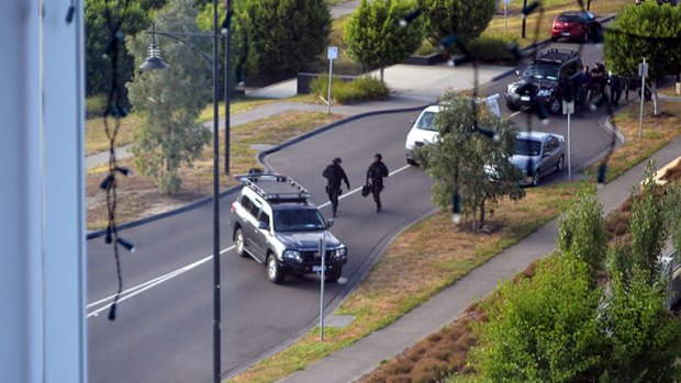 Age.com.au reader Sian captured this picture of tactical officers approaching her apartment building in Cumberland Drive, where two men have kept police at bay.