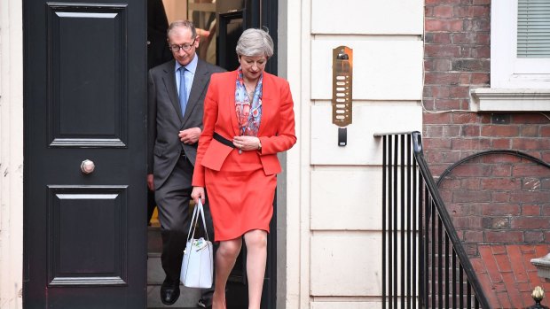 Theresa May leaves Conservative Party Headquarters with her husband Philip on Thursday.