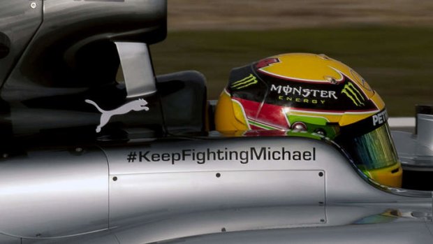 Lewis Hamilton drives the new Mercedes W05 displaying a message of support for Michael Schumacher.