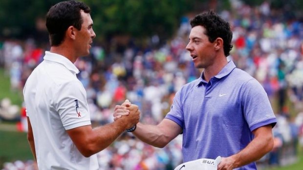 The money man: Billy Horschel shakes hands with Rory McIlroy after winning both the Tour Championship and the FedEx Cup playoffs.