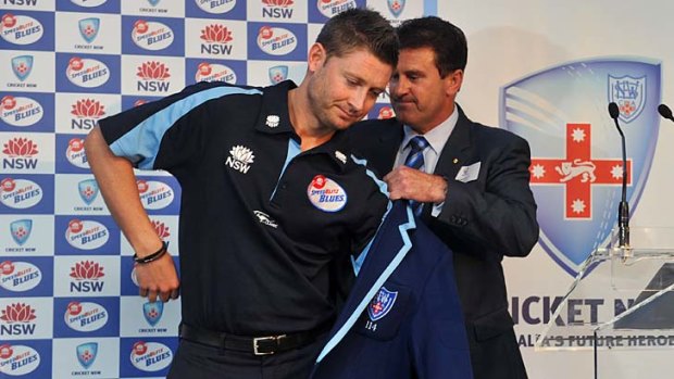Blazer day ... Michael Clarke gets his Blues jacket from Mark Taylor to launch NSW's season yesterday.