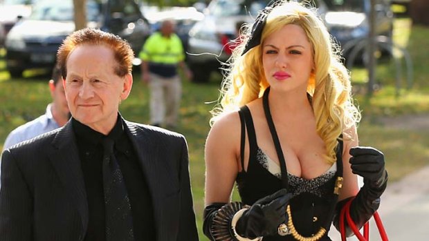 Geoffrey Edelsten, pictured with his new partner at the funeral of AFL great  Tom Hafey.