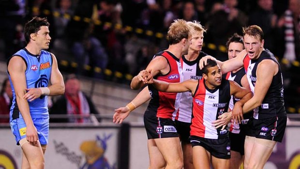 What he Saad: Saints players celebrate a goal with rookie Ahmed Saad, centre, in the win over Carlton last night.