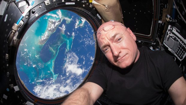 Scott Kelly takes a photo of himself inside the Cupola, a special module of the International Space Station. 