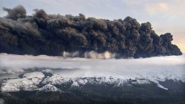 Smoke and steam hangs over the volcano under the Eyjafjallajokull glacier in Iceland.