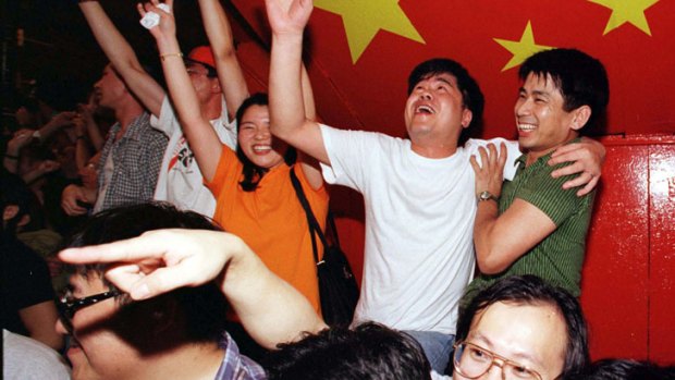 Revellers in Lan Kwai Fong in central Hong Kong celebrate in the streets the handover of sovereignty to China at the stroke of midnight July 1 in 1997.