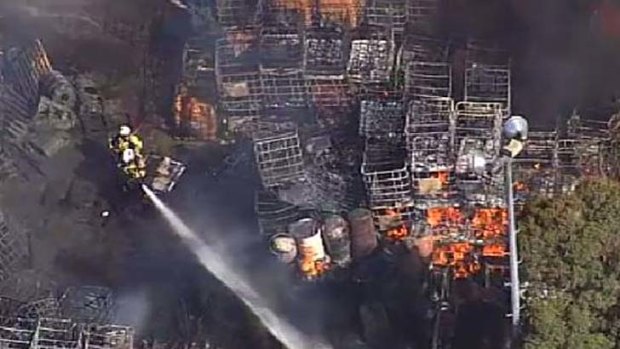 Firefighters try to control the blaze at the honey factory at  Richlands, southwest Brisbane.