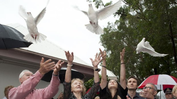 Keith Golinski, left, Suzannah MacCraken, Leonie MacCracken and Raymond MacCracken release doves with other mourners at the funeral for the wife and three children of celebrity chef Matt Golinski.