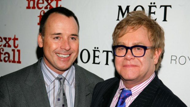 Proud dads ... Elton John and David Furnish get a baby for Christmas.