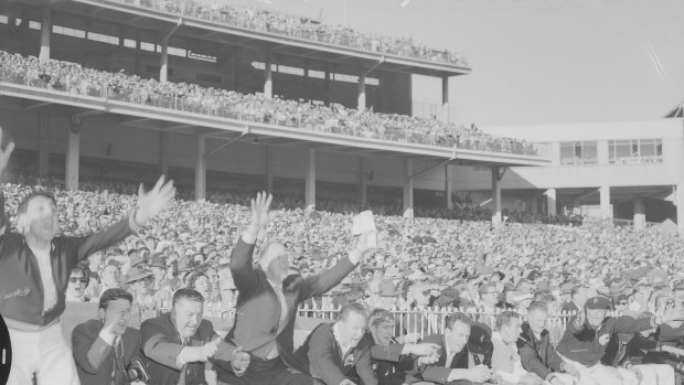 Carlton coach Ken Hands (fourth from left) cheers from the bench as Carlton defeat Geelong in the 1962 replay.