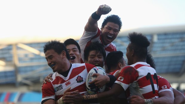 Japan celebrates their second try against South Africa.