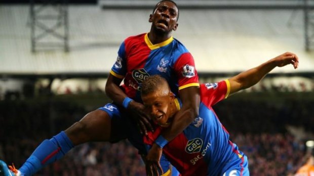 Jubiliation: Gayle is embraced by his teammate Yannick Bolasie.