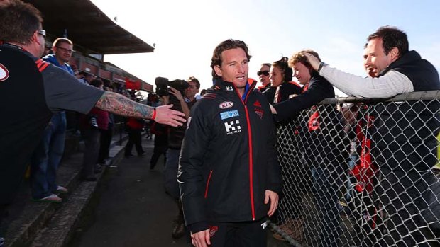 Bombers coach James Hird walks onto the ground after a media conference on Saturday.