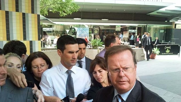 Water Utilities Minister Stephen Robertson speaks to the media outside the flood inquiry.