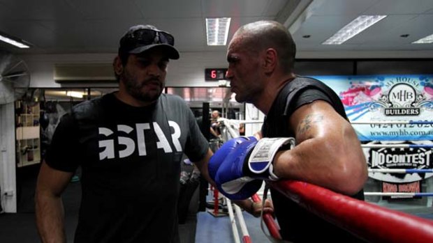 Hitting back ... Anthony Mundine, right, has attacked the delays in the deal between Greg Inglis and Russell Crowe.