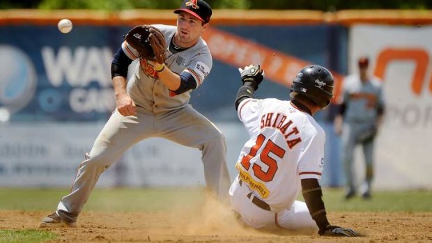 Canberra Cavalry's Kohei Shibata, right, slides safely into second base.
