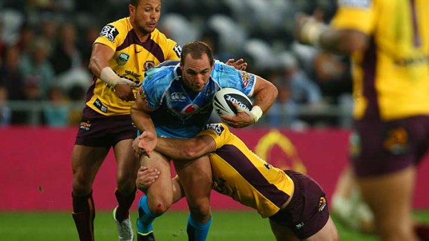 Simon Mannering is tackled.