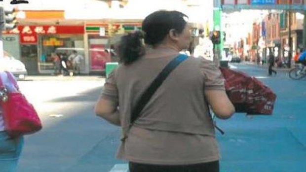A photograph of one of the handbag scammers, taken during a scam in the city in March.