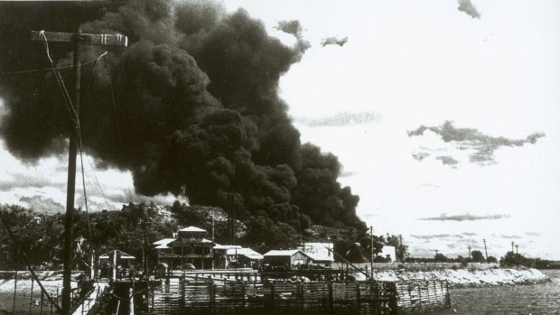 Darwin, 19 February 1942. People at Government House look at the smoke billowing from ships ablaze in the harbour after the first Japanese air raids.
