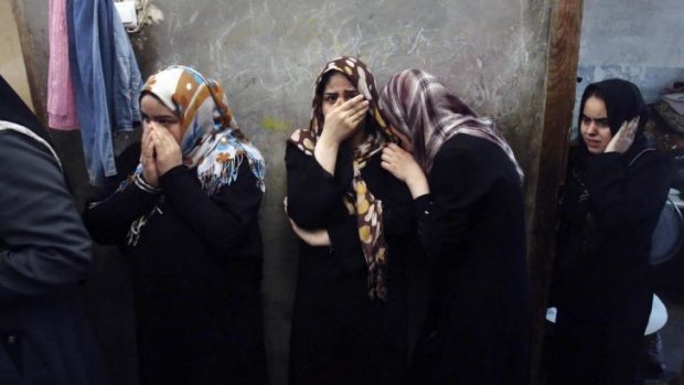 Relatives mourn the deaths of family members, killed in Israeli air strikes.