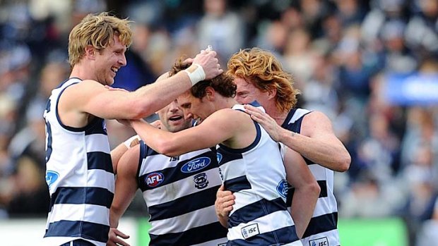 Catlike: Geelong's debutant Mitch Brown is congratulated by teammates after kicking his first goal in the AFL.