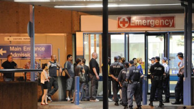 Gunshot wounds ... associates of Sam Ibrahim, including his wife Karen (with blonde hair and blue jacket), arrive at Westmead Hospital last night.