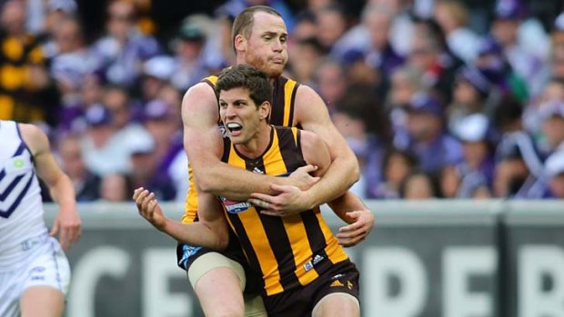 Luke Breust is congratulated by teamate Jarryd Roughead after scoring the goal to seal the 2013 grand final.