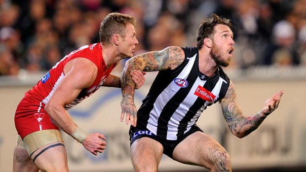 Sydney's Mitch Morton and Collingwood's Dane Swan both await the arrival of the ball.
