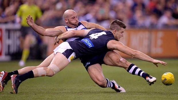 At a stretch: Geelong forward Paul Chapman (left) and Carlton midfielder Bryce Gibbs battle for the ball during the Cats' victory.