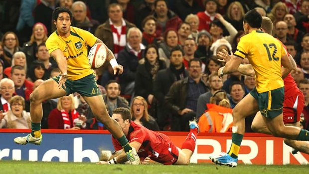 Joe Tomane of Australia offloads to Christian Leali'ifano for the Wallabies to score their opening try.