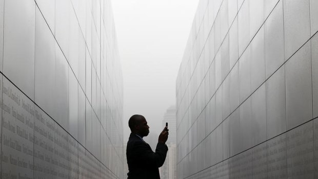 Todd McCormick takes a photograph of names on the walls of the newly constructed "Empty Sky Memorial" at Liberty State Park in New Jersey.